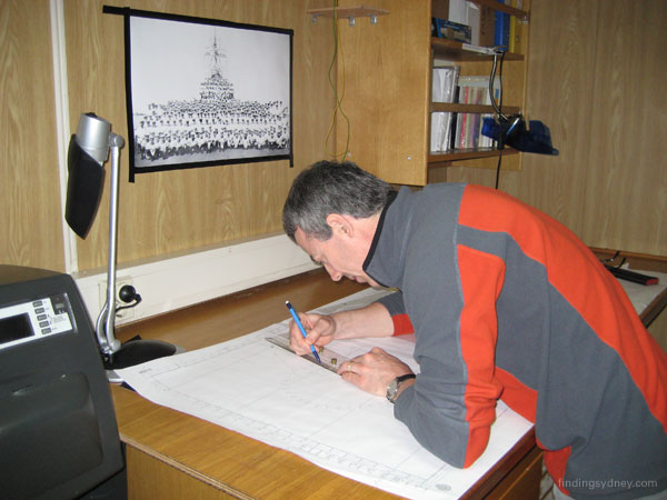 David Mearns working at a charting table.